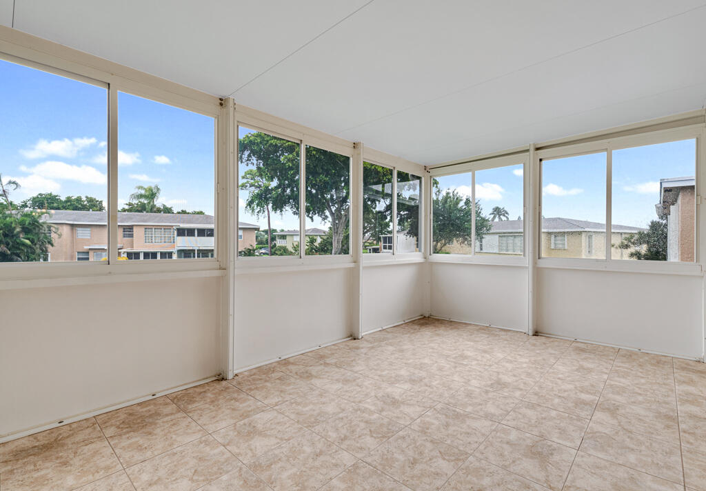 2411 Papaya Drive, Unit 202 Delray Beach, FL 33445 - Photo 20 of 23 an empty room with a large window