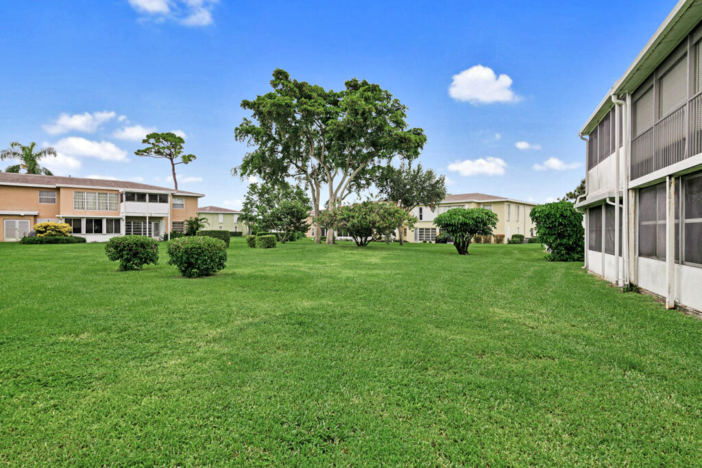 2411 Papaya Drive, Unit 202 Delray Beach, FL 33445 - Photo 22 of 23 a view of a house with a backyard