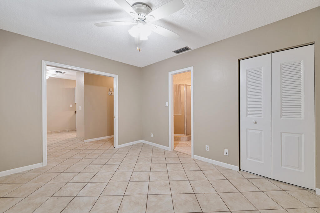 2411 Papaya Drive, Unit 202 Delray Beach, FL 33445 - Photo 7 of 23 a view of an empty room and chandelier fan