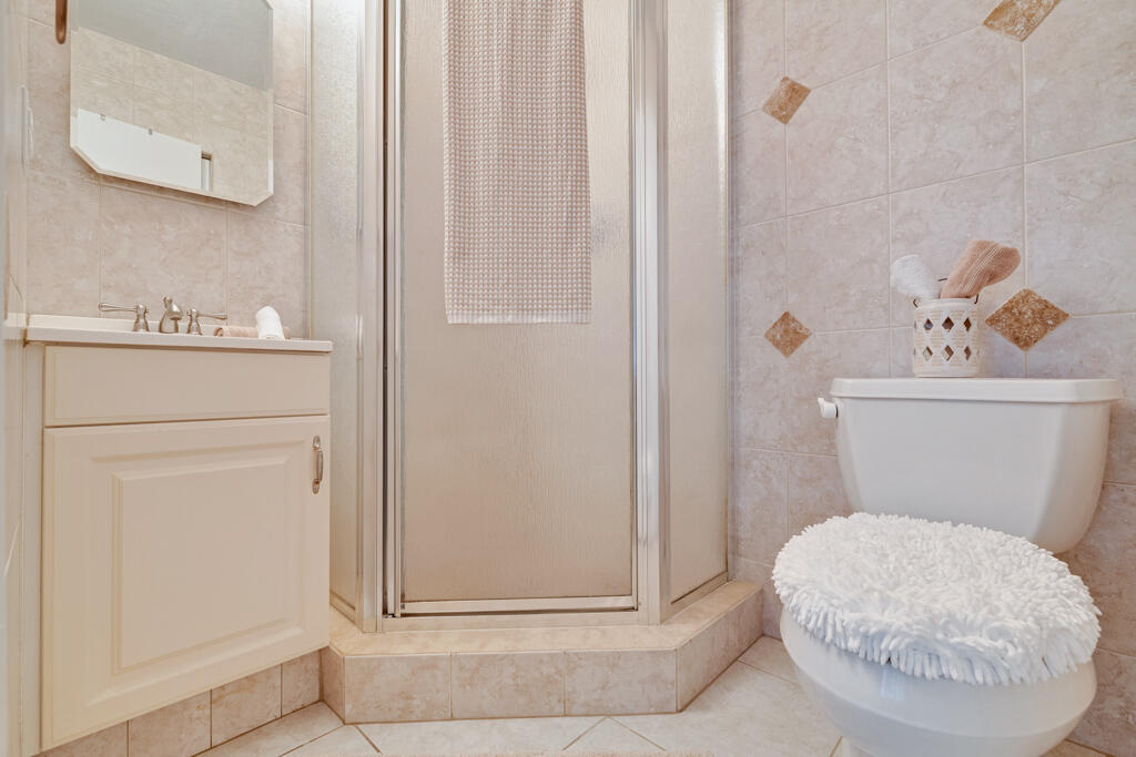 2411 Papaya Drive, Unit 202 Delray Beach, FL 33445 - Photo 9 of 23 a bathroom with a toilet and a sink