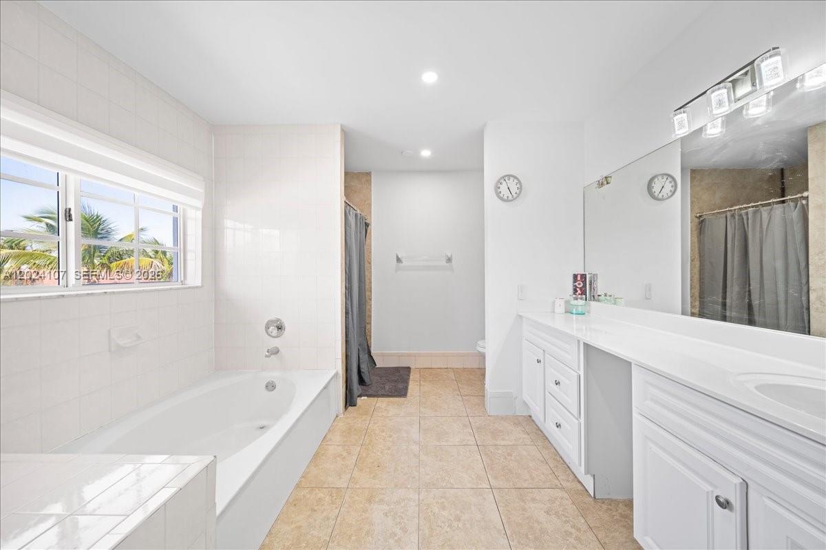 15341 Southwest 36th Street Miami, FL 33185 - Photo 17 of 56 a spacious bathroom with a tub sink shower and mirror