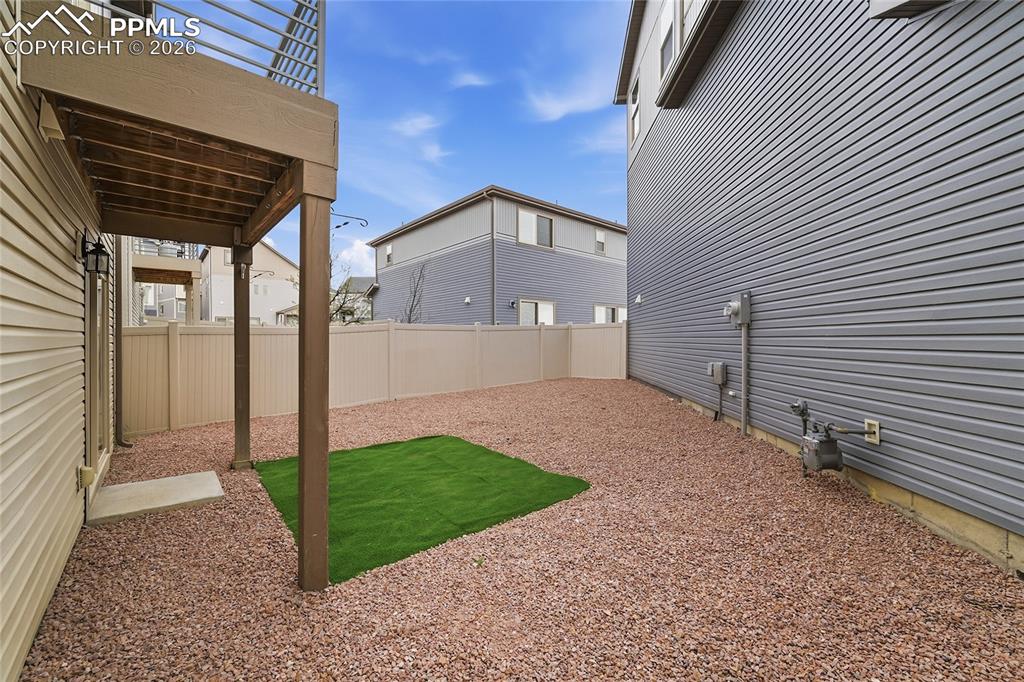 9414 Timberlake Loop Colorado Springs, CO 80927 - Photo 29 of 40 Fenced backyard featuring a patio area with rocks and turf