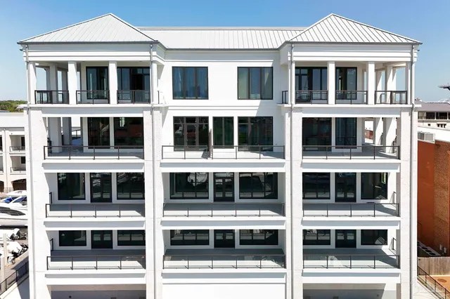 a roof deck with table and chairs