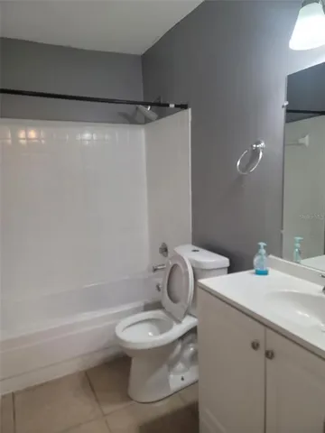 a view of an empty room with window and closet area