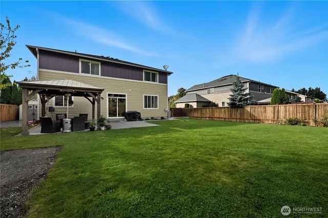 a view of a house with backyard and porch