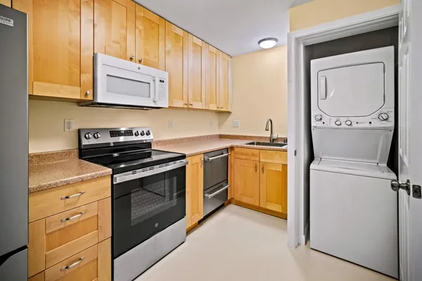 a kitchen with a stove top oven sink and cabinets