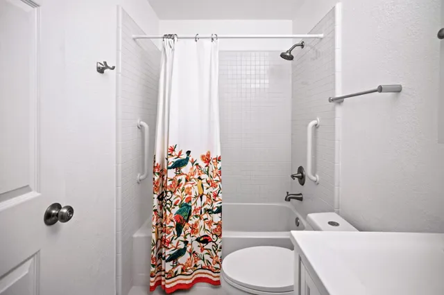 a bathroom with a toilet a sink and shower