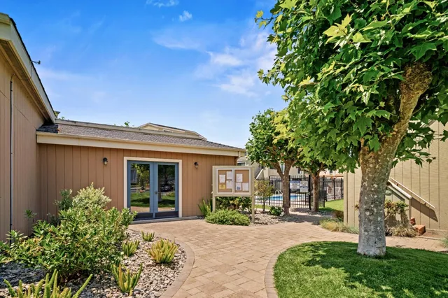 a front view of a house with a garden