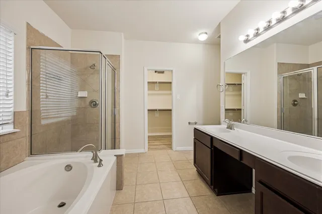 an empty room with wooden floor chandelier fan and windows