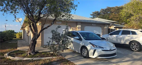 a front view of a house with parking area