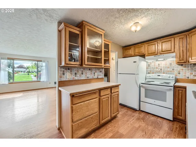 a kitchen with white cabinets and white appliances