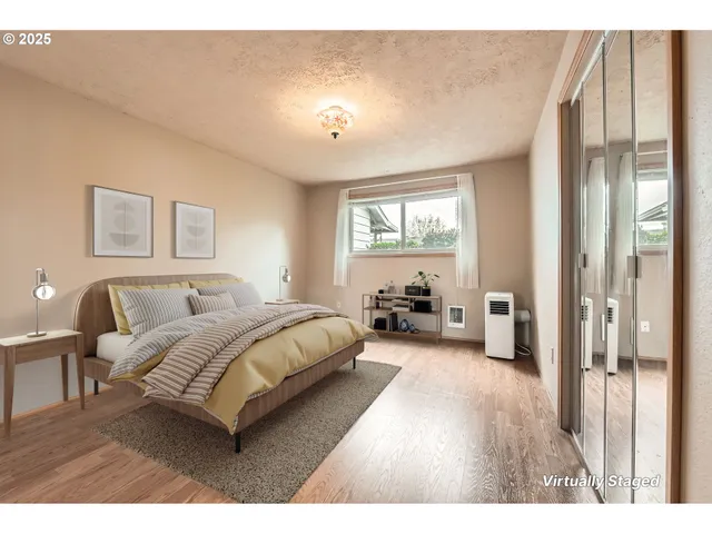 a spacious bedroom with a bed and a large window