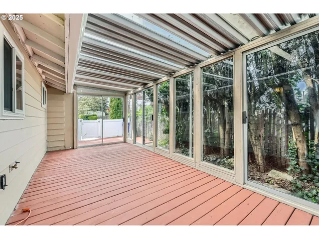 a outdoor view of a house with backyard and balcony