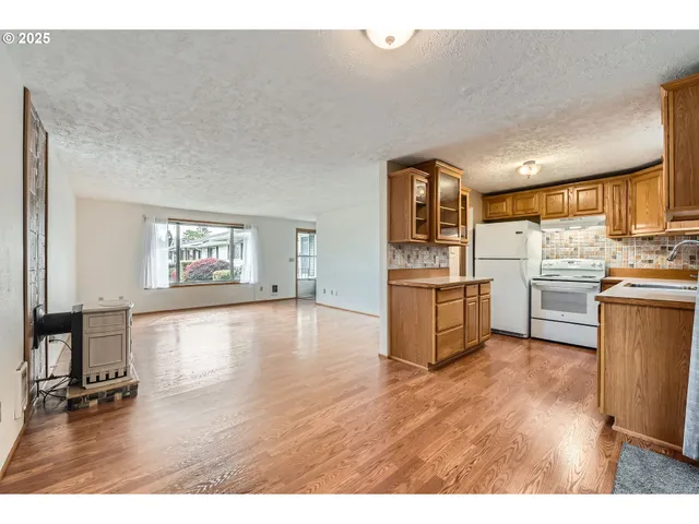 a kitchen with stainless steel appliances granite countertop a stove and a refrigerator