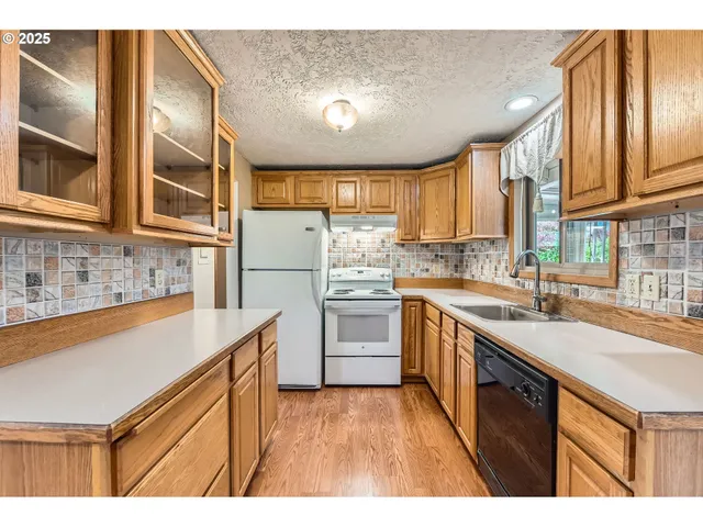 a kitchen with a sink window and cabinets