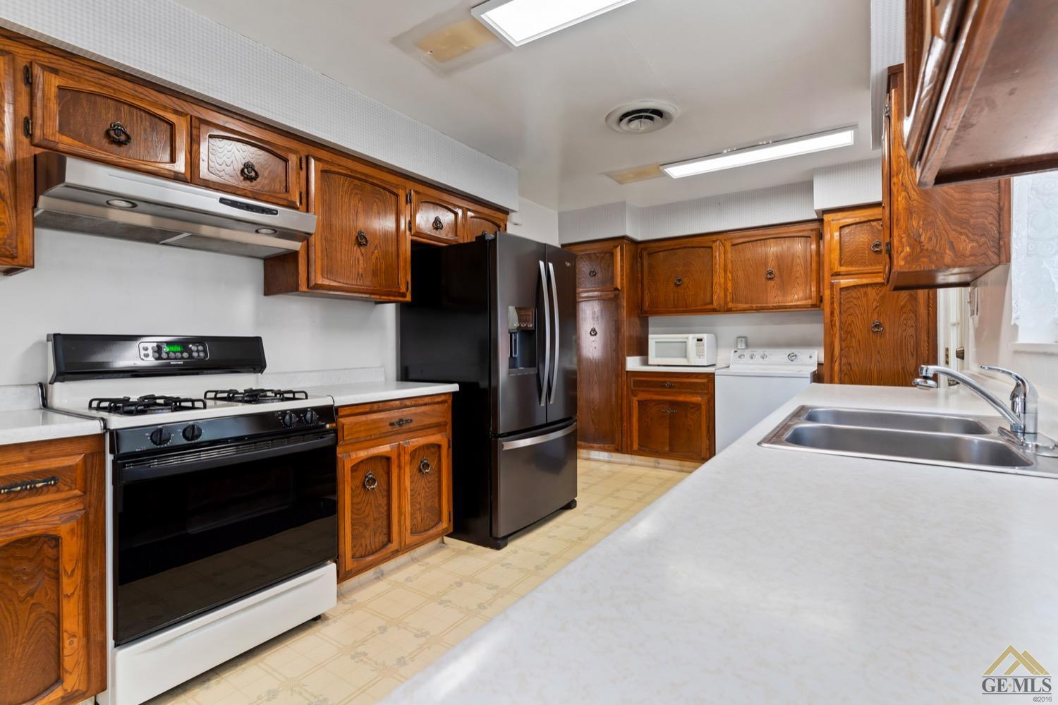 Undisclosed Address Bakersfield, CA 93304 - Photo 11 of 30 a kitchen with stainless steel appliances granite countertop a stove a sink and a refrigerator