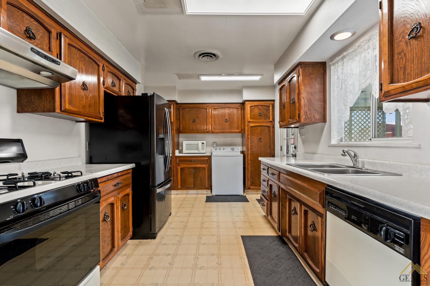 Undisclosed Address Bakersfield, CA 93304 - Photo 14 of 30 a kitchen with stainless steel appliances granite countertop a stove a sink dishwasher and a refrigerator