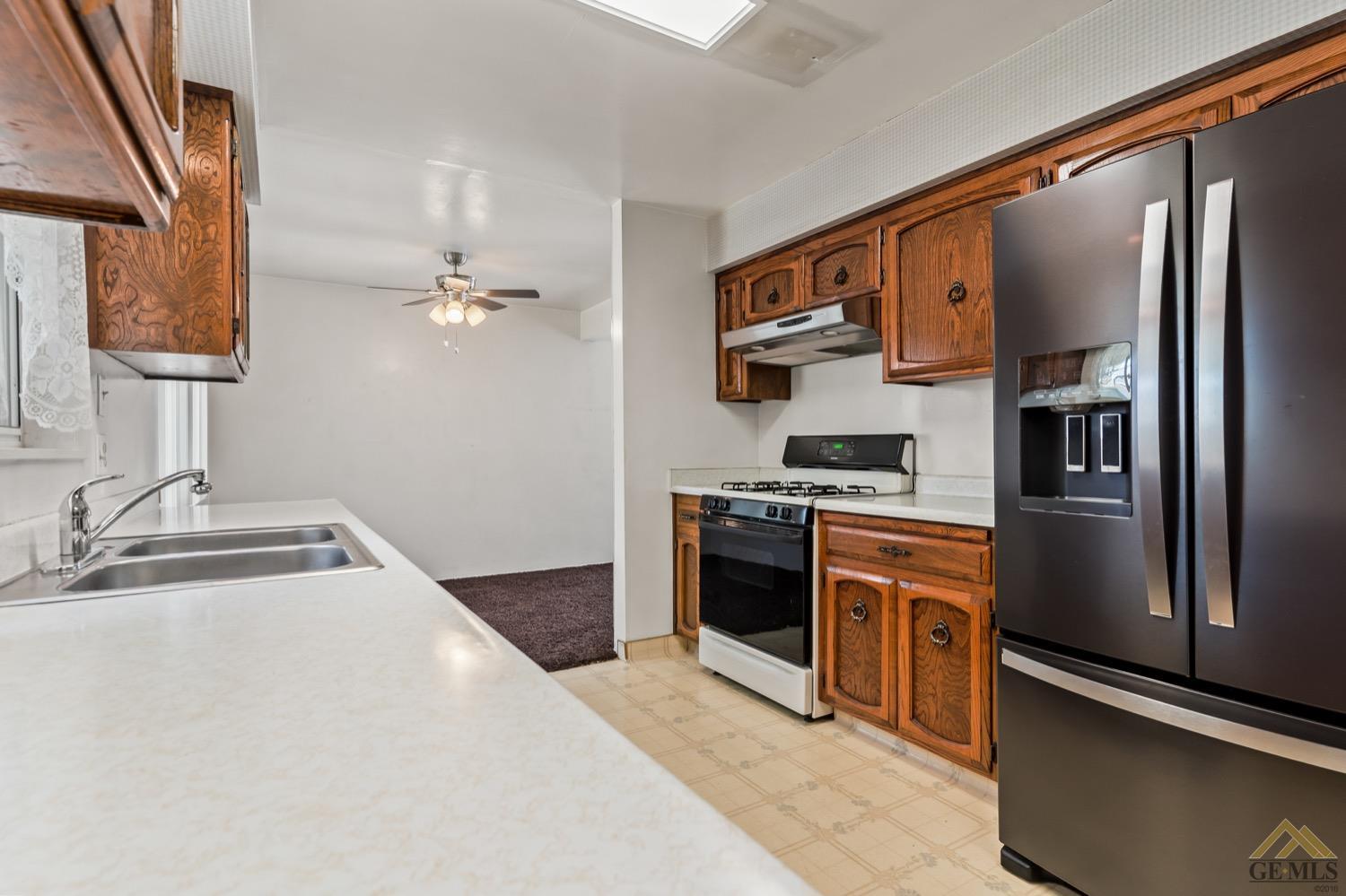Undisclosed Address Bakersfield, CA 93304 - Photo 15 of 30 a kitchen with stainless steel appliances granite countertop a refrigerator and a sink