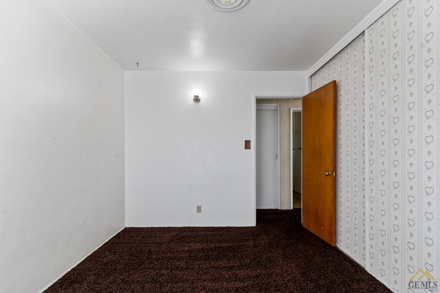 Undisclosed Address Bakersfield, CA 93304 - Photo 18 of 30 a view of an empty room with wooden floor and closet
