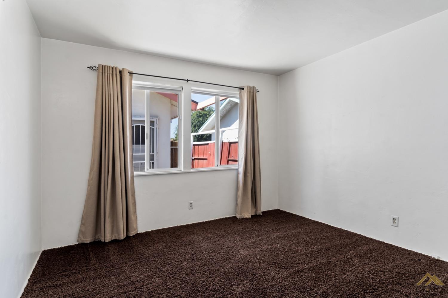Undisclosed Address Bakersfield, CA 93304 - Photo 20 of 30 a view of an empty room with wooden floor and a window
