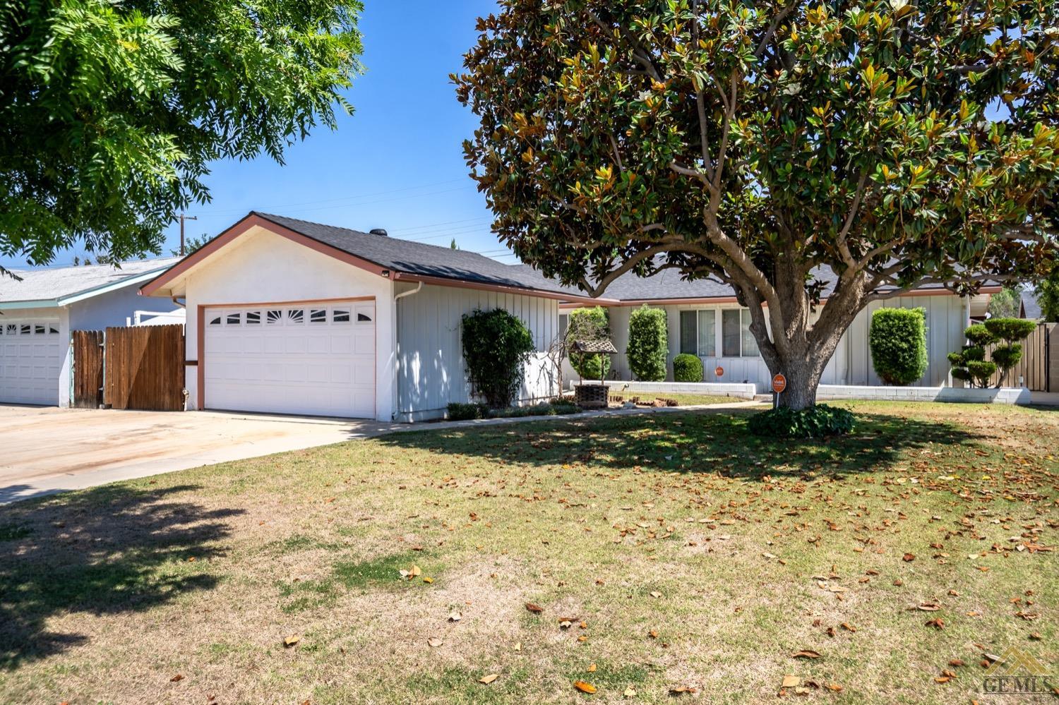 Undisclosed Address Bakersfield, CA 93304 - Photo 2 of 30 a front view of a house with a yard and garage