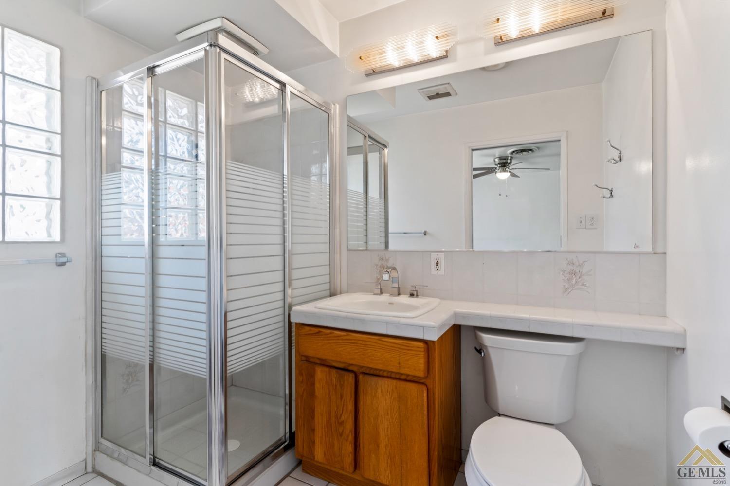 Undisclosed Address Bakersfield, CA 93304 - Photo 24 of 30 a bathroom with a sink a toilet and shower