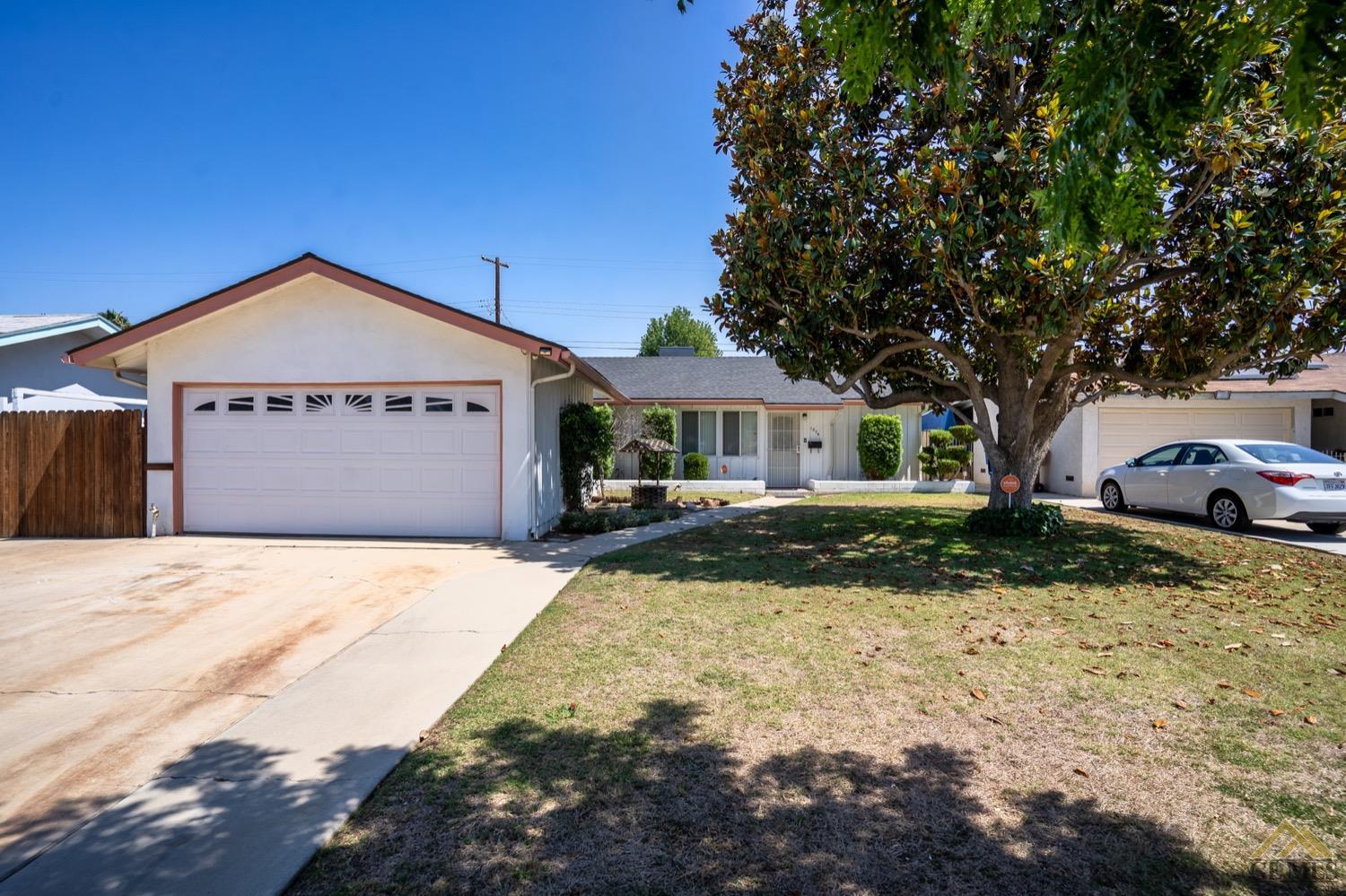 Undisclosed Address Bakersfield, CA 93304 - Photo 3 of 30 a front view of a house with a yard
