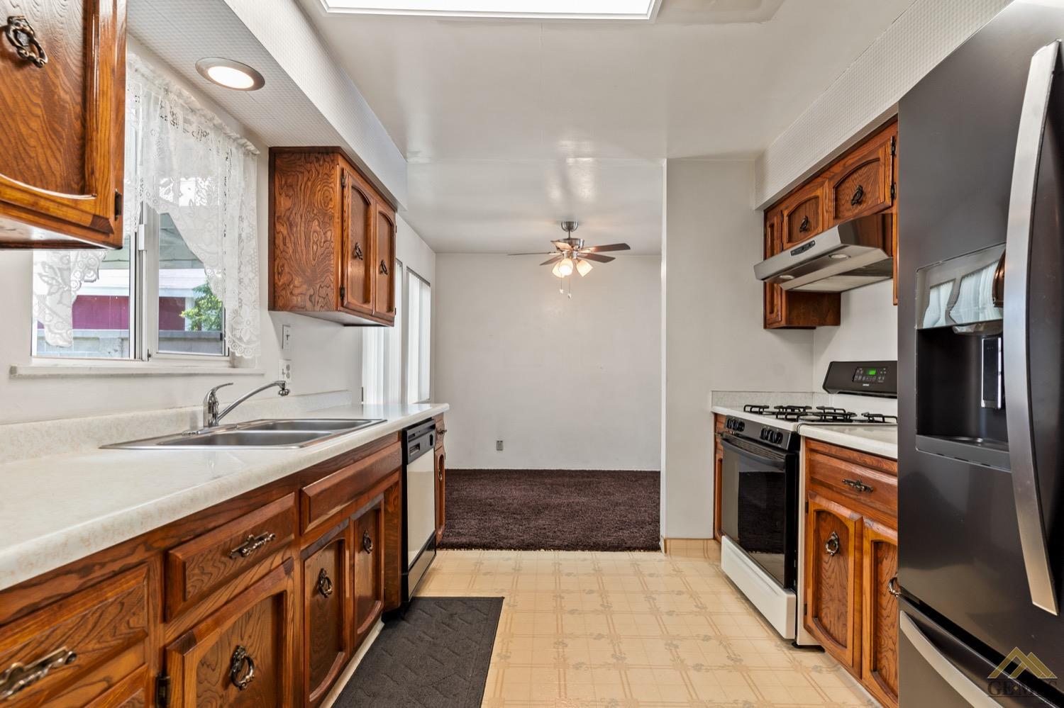 Undisclosed Address Bakersfield, CA 93304 - Photo 9 of 30 a kitchen with stainless steel appliances granite countertop a sink stove and refrigerator