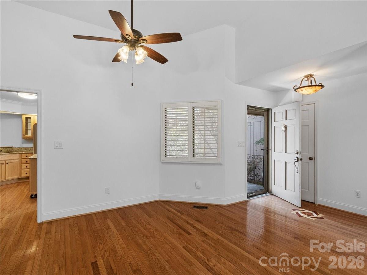 21 Ridge Terrace Asheville, NC 28804 - Photo 20 of 47 a view of an empty room with wooden floor and a ceiling fan