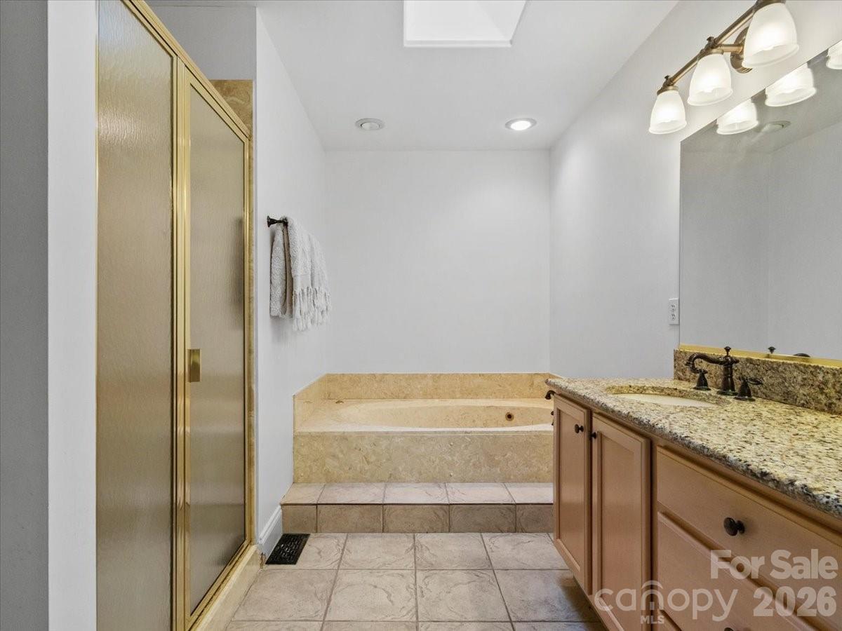 21 Ridge Terrace Asheville, NC 28804 - Photo 26 of 47 a bathroom with a tub sink and shower