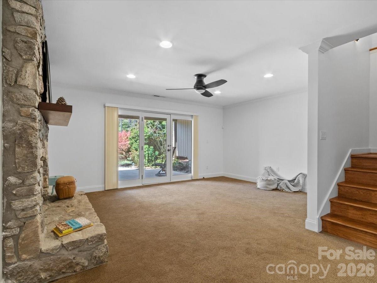 21 Ridge Terrace Asheville, NC 28804 - Photo 30 of 47 a view of a livingroom with wooden floor and a ceiling fan