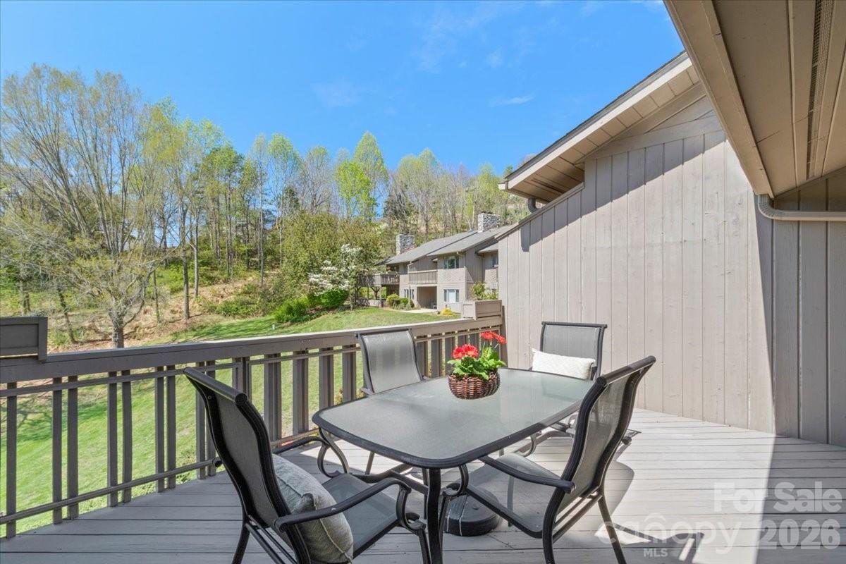 21 Ridge Terrace Asheville, NC 28804 - Photo 10 of 47 a balcony with wooden floor table and chairs