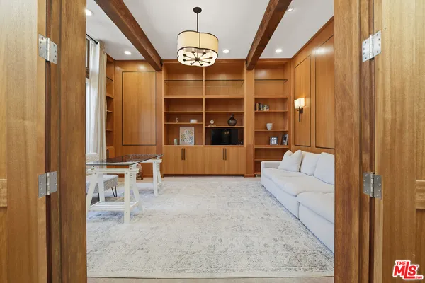a dining room with furniture a chandelier and wooden floor