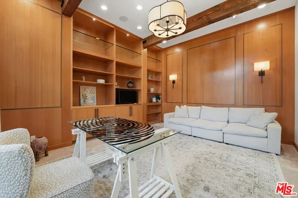 a bedroom with a bed and a large mirror