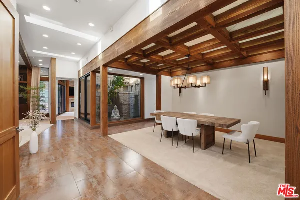 a view of a hallway with wooden floor and furniture