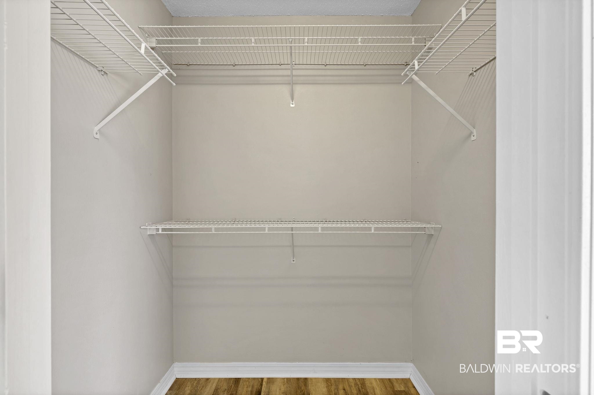 10238 Grove Drive Fairhope, AL 36532 - Photo 20 of 39 Walk in closet featuring wood finished floors