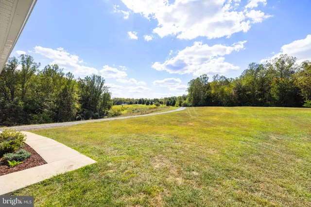 a dining room with furniture a chandelier and wooden floor