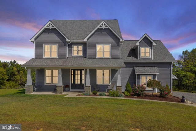 a front view of a house with a garden and yard