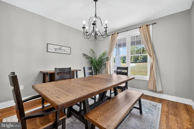 a kitchen with stainless steel appliances granite countertop a kitchen island a stove a table and chairs