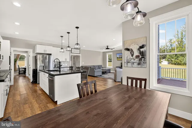 a view of a livingroom with wooden floor and stairs