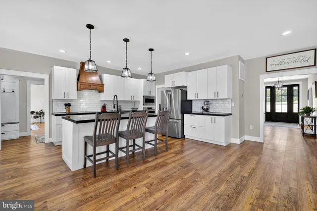 a view of a room with wooden floor and stairs