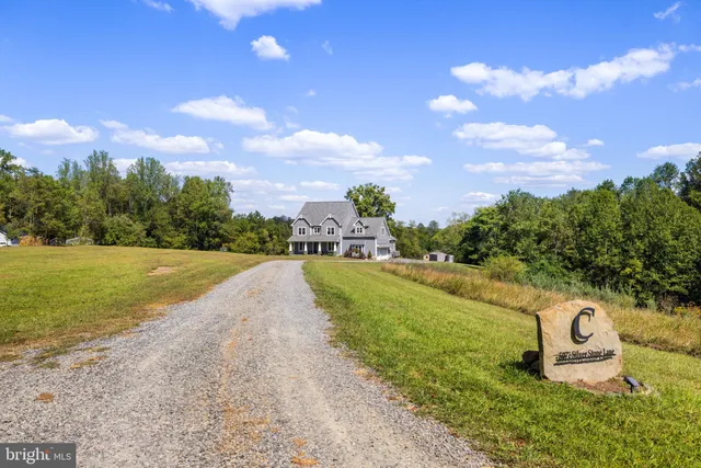 a front view of a house with swimming pool and porch