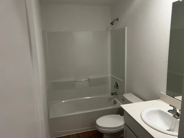 a bathroom with a toilet a sink and shower
