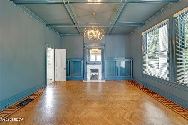 a view of an empty room with a fireplace and a window