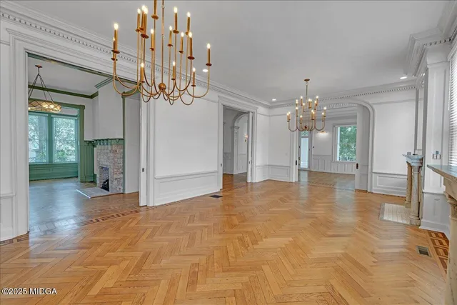 a kitchen with kitchen island a counter top a stove a sink and a large window