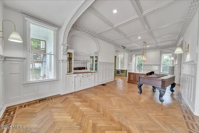 a view of a room with a large windows and plants