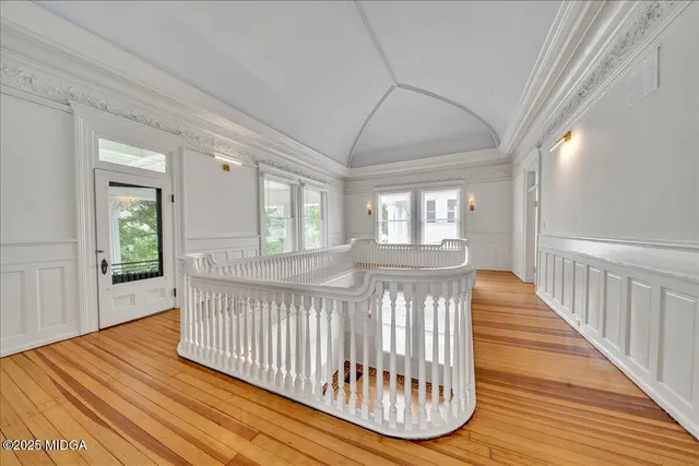 a living room with furniture a flat screen tv and a large window