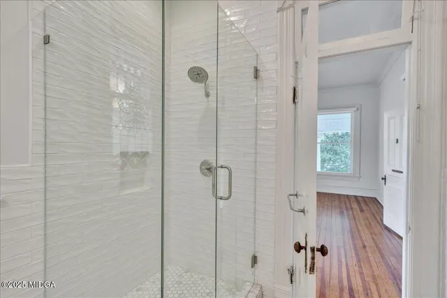 a spacious bedroom with a large bed and a large window