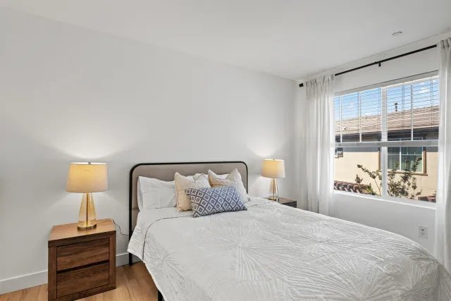 a bedroom with a bed and night stand