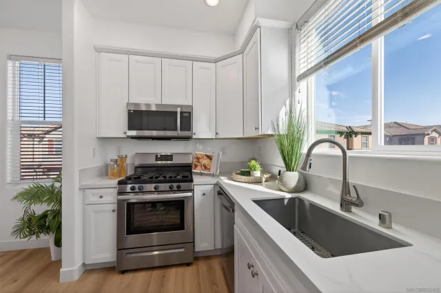 a kitchen with stainless steel appliances granite countertop a stove and a microwave